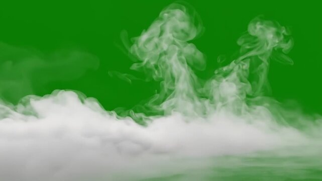 Low angle shot of white smoke or fog swirling and creeping across green screen background for visual effects.