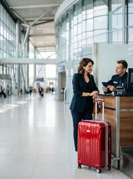 Businesswoman checking in for flight at airport counter