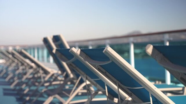 Blue sunbeds on a cruise liner deck with gentle camera movement