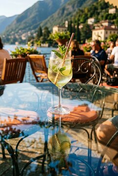 Refreshing spritz cocktail with lime and mint on glass table