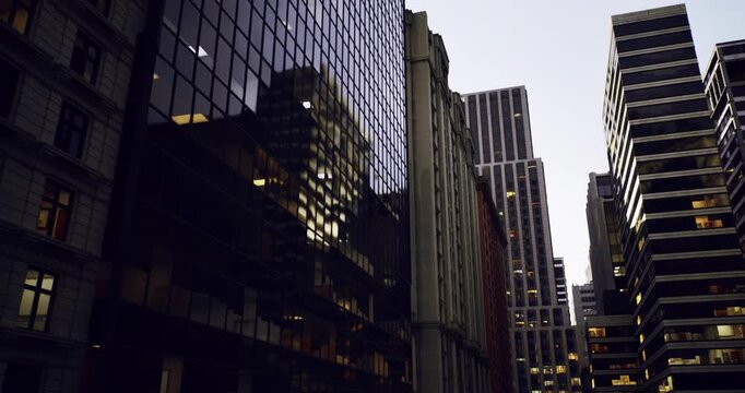 soft twilight corridor framed by glass and masonry, rows of illuminated offices signaling evening activity, narrow street vanishing into distant modern towers,