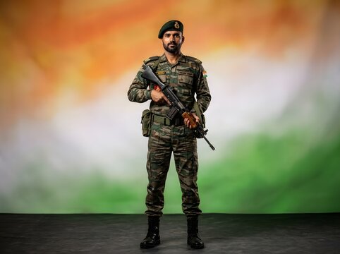 Indian army soldier standing in attention against a blurred indian tricolor flag background, symbolizing patriotism, honor, and dedication to the nation