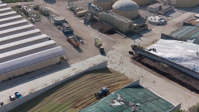 Aerial view of a modern Lombardy, Italy farm integrating livestock, silage storage, anaerobic digesters and greenhouses.