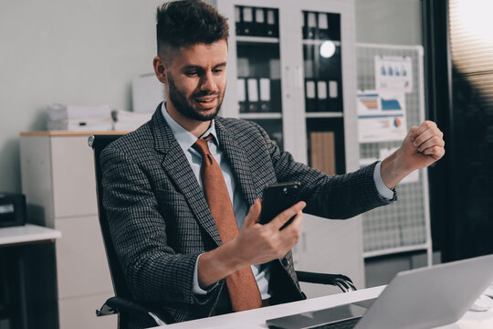 Two partners, team of professional business people working, discussing, writing notes at desk. Mature focused senior mentor leader man showing young woman manager project on laptop in modern office