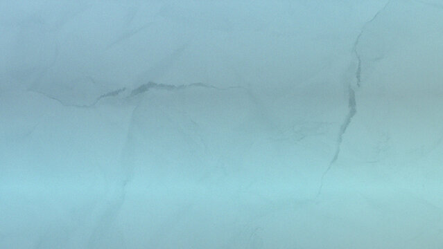 Light blue textured stone surface with subtle natural veining background material interior abstract backdrop structure