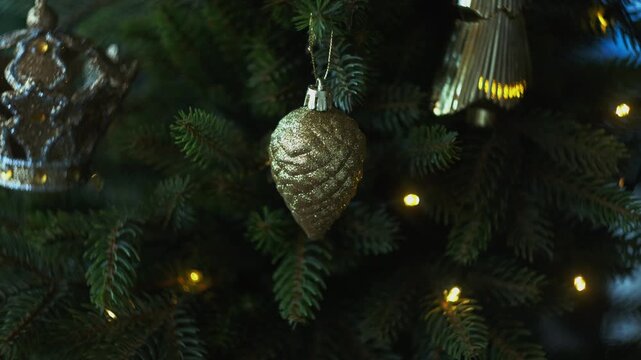 Woman decorating Christmas tree with Christmas ornaments.