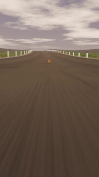 Vertical video: Driving camera surveying two-lane rural road up crest, showing yellow line and cone