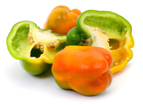 sliced and whole bell peppers Capsicum annuum isolated on white background