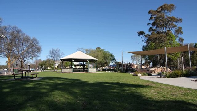 A public park in Keith, South Australia, with a central park rotunda pavilion, children's playground, picnic tables, shade sails, and well-maintained green lawn.