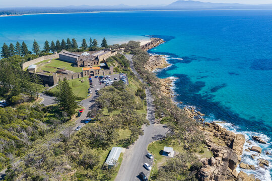 Aerial view of the historic Trial Bay Gaol overlooking the turquoise waters and rocky coastline of Trial Bay.