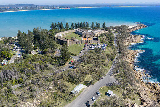 Aerial view of the historic Trial Bay Gaol overlooking the turquoise waters and rocky coastline of Trial Bay. 