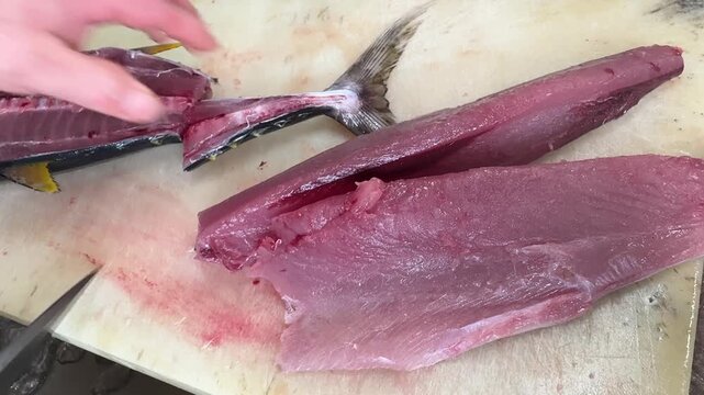 Tuna Fillet Blocks and Fish Skeleton, Chef Cleaning with a Towel