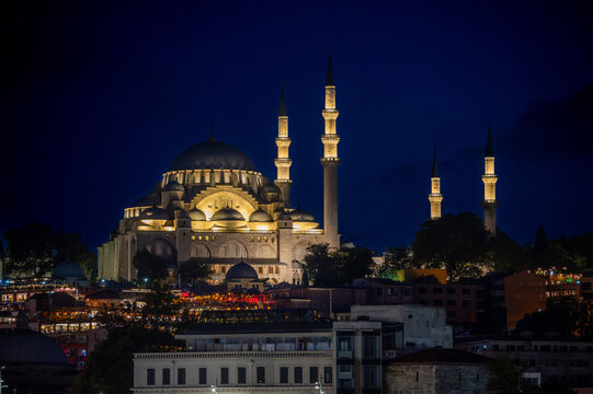 Istanbul,turkey,august 4, 2025. Suleymaniye mosque standing prominently, its domes and minarets brightly lit against the dark night sky in istanbul, turkey