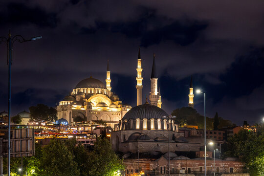 Istanbul,turkey,august 4, 2025. Suleymaniye mosque with its grand domes and minarets illuminated against the cloudy night sky, showcasing historical architecture