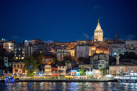 Istanbul,turkey,august 4, 2025. Istanbul skyline at dusk with galata tower glowing over the bosphorus, lights reflecting on the water and historic waterfront buildings