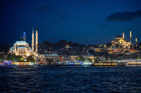 Istanbul,turkey,august 4, 2025. Istanbul night skyline with yeni cami and suleymaniye mosques illuminated along the bosphorus, reflections on the water