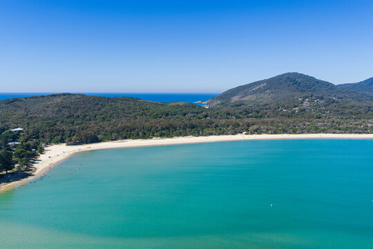 An aerial view across the expansive sandy shoreline of Front Beach at Trial Bay, South West Rocks, New South Wales, Australia. 