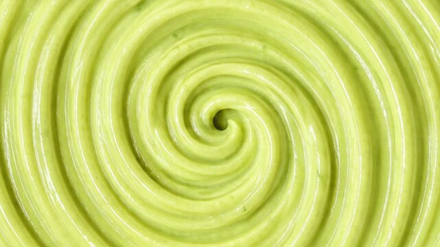 Close Up Macro Shot of Light Green Creamy Paste or Avocado Puree Swirl Motion Background Smooth Spiral Vortex Animation of Light Green Liquid Texture