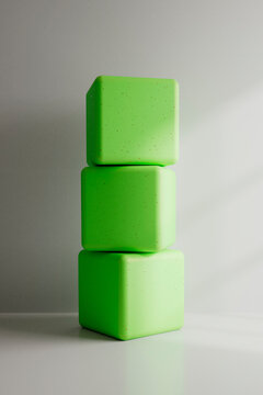 Stacked Green Cubes on Minimal Background