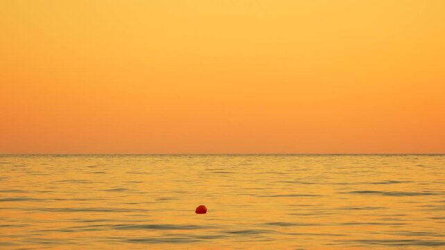 Buoy ocean sunset orange sea horizon calm water floating marker serene nature landscape peaceful evening coastal view