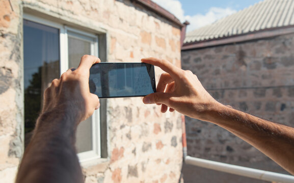 Man taking window by mobile phone.