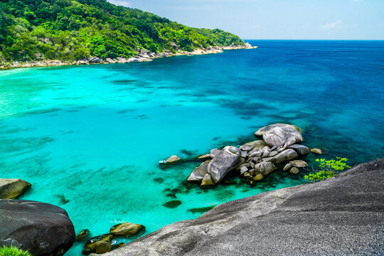 bay in sea near an island with blue water