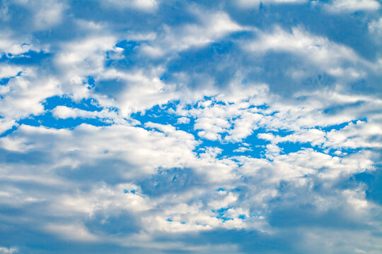 white dense clouds in a blue sky