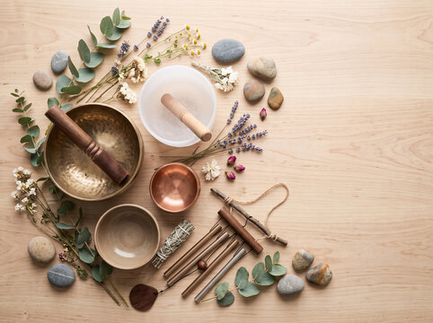 Sound healing still life with copper bowl, crystal bowl, lavender and sage bundle