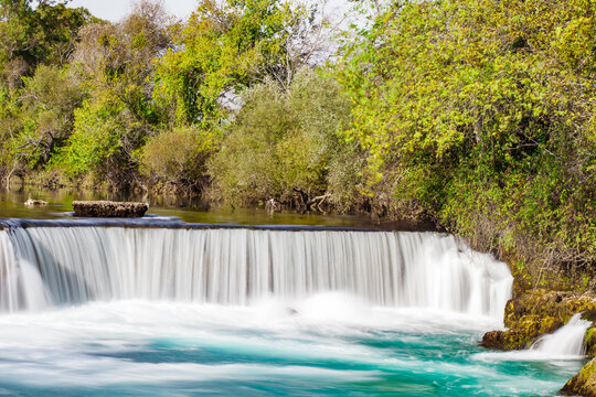 wide waterfall on river, blurred movement of water, long exposure