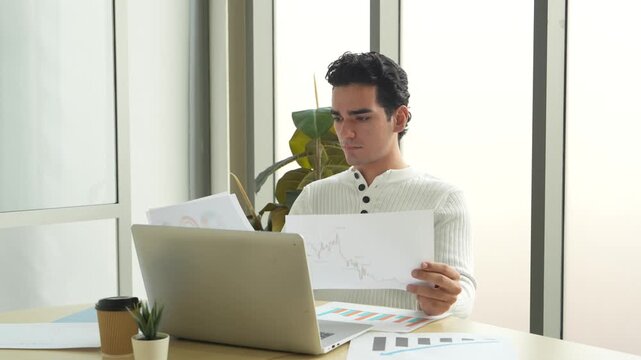 A businessman sits on a chair in the company meeting room during his lunch break, reading information and reflecting on work while feeling relaxed and at ease.
Send feedback
