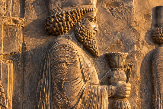 Weathered stone bas-relief from Persepolis depicting a tribute bearer.