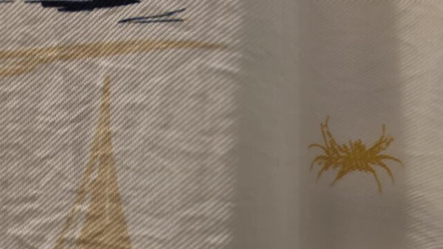 Yellow crab graphic printed on white fabric with textured nautical pattern design background