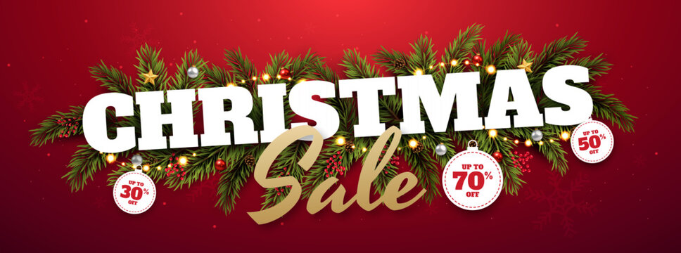 Christmas Sale Wide Banner with Festive Pine Garland, Holiday Discount Tags, Ornaments and Red Background