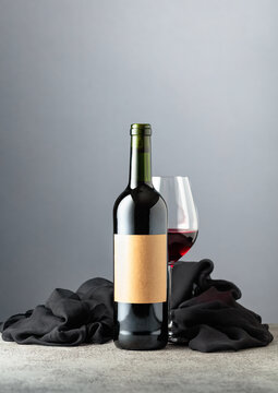 Bottle of red wine on a grey background.