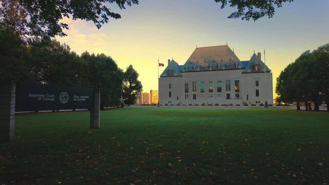 Ottawa, Ontario, Canada - September 28, 2026: Wide view of the Supreme Court of Canada building facade at sunset with the official entrance sign in the foreground lawn area