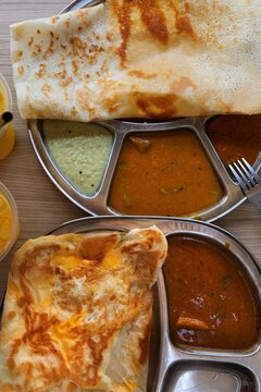 South Indian food in Singapore. Dosa or thosai (batter bread) served with sambar and chutney sauce in an Indian restaurant in Little India.