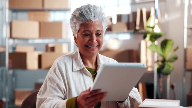 Happy, woman and tablet with boxes for ecommerce, research and confirm order for stock control. Mature person, startup and review in office with tech, inventory availability and catalog for delivery