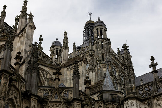 Detailed view of the ornate Gothic architecture, towers, pinnacles and stone sculptures of Saint John&rsquo;s Cathedral in &rsquo;s-Hertogenbosch, Netherlands, under an overcast sky.