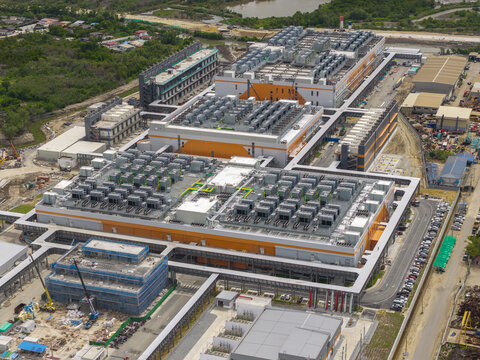 Aerial view of a large hyperscale data center facility with industrial buildings, rooftop cooling units, parking areas, and construction infrastructure in Bangkok, Bangkok, Thailand.
