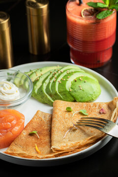 Roasted thin pancakes with smoked salmon and sauce