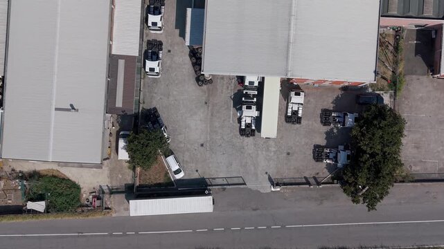 Aerial View of Trucking Company Facility with White Trucks in Italy