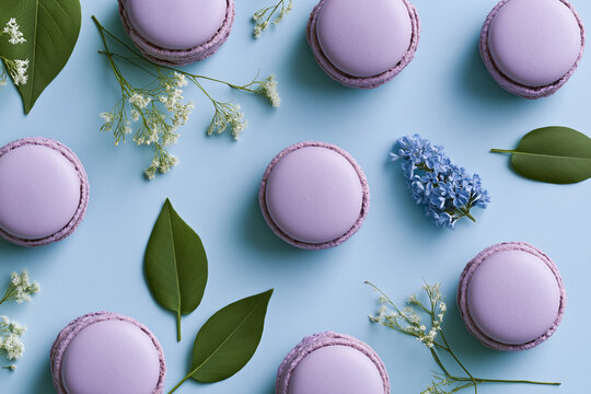 Easter celebration purple macarons with floral decoration on blue
