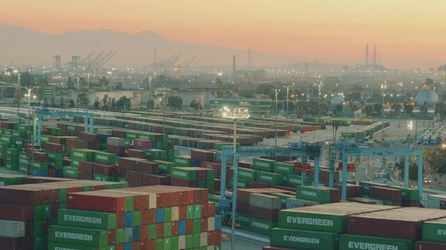 Los Angeles, California, USA - October 1, 2026: Massive container terminal at the Port of Los Angeles stacked with intermodal cargo boxes at sunrise