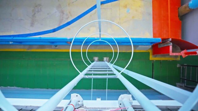 Tracking Shot Looking Down Playground Slide Ladder with Circular Rungs