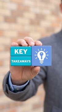 Business professional holding wooden blocks with key takeaways message and lightbulb graphic business strategy corporate training problem solving knowledge management