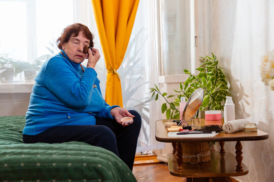 Elderly Caucasian woman enjoys self care through grooming and makeup. Retirement and healthy lifestyle.