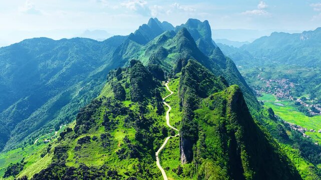 High angle view of Longji mountain ridge in Liupanshui with a winding road leading through lush green karst scenery.