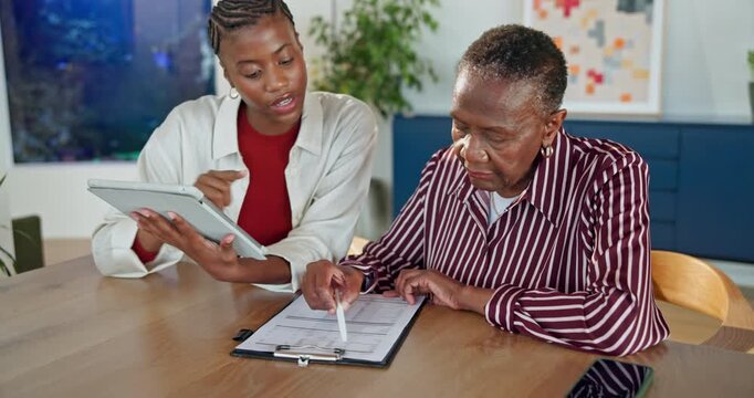 Paperwork, senior mother and woman with tablet for help, insurance claim or verify info on form. Black family, mom and adult daughter with digital review, pension application and assistance in home