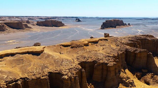 High angle view reveals vast yardang landforms stretching across the arid desert terrain of Dahaidao in Xinjiang under a clear sky.