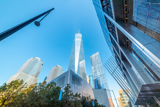Modern skyscrapers in Lower Manhattan under a blue sky viewed from below